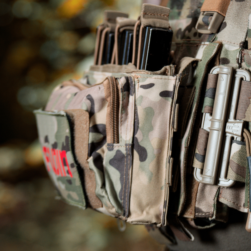 Camouflage tactical pouch with multiple compartments and a visible brand logo.